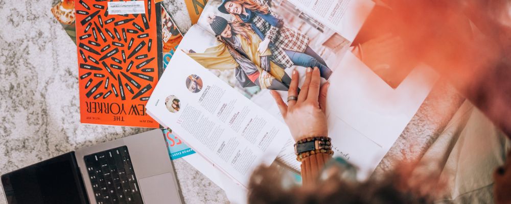 picture of alison with a magazine finding photos for a collage